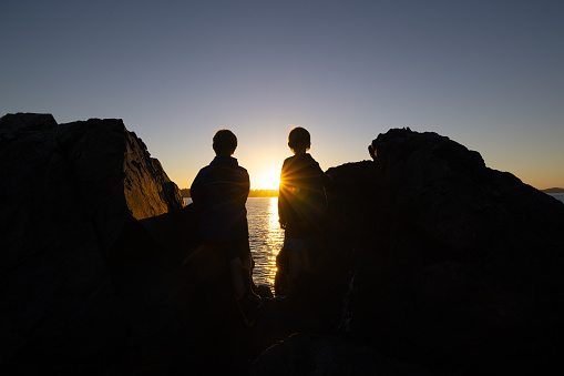 boys watching sunset