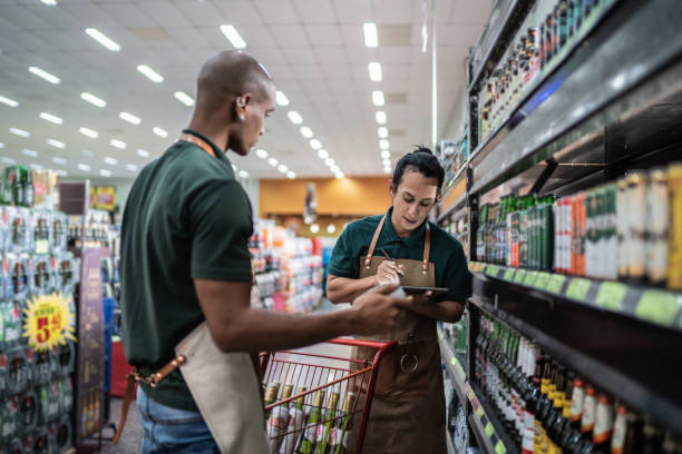istock Coworkers working in a supermarket - including a non-binary person 1405275423