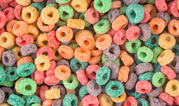 istock Delicious and nutritious fruit cereal loops as background, top view. Healthy breakfast. 1405276356