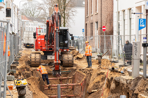 Arnhem, The Netherlands, January 18, 2022; Road works with an excavator in a broken-up city street in the center of Arnhem.