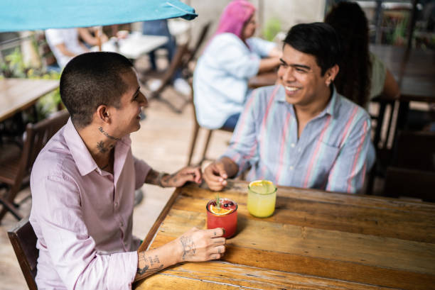 istock Gay couple talking and drinking on a bar 1405279355