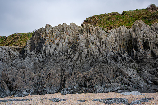 Slate, quartz and sandstone rock formations at Barricane Beach, Woolacombe, Devon, UK