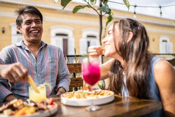 istock Friends having fun eating and drinking on restaurant 1405280238