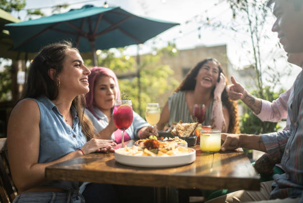istock Friends having fun drinking and eating at restaurant 1405280587