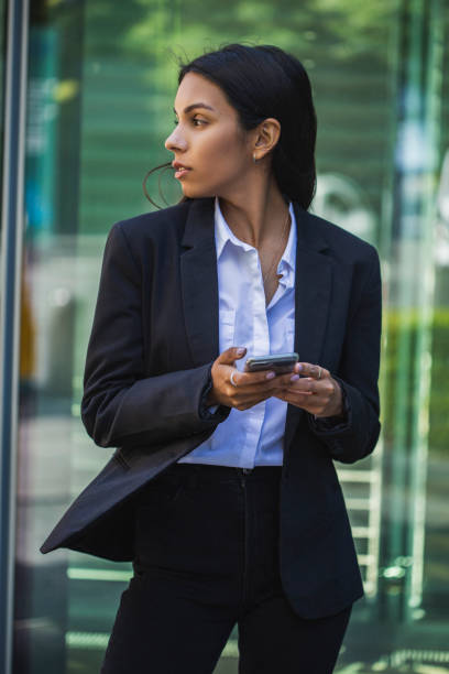 istock Woman using mobile phone on the street 1405280588