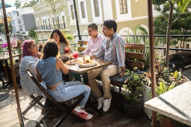 istock Friends having fun drinking and eating at restaurant 1405280602