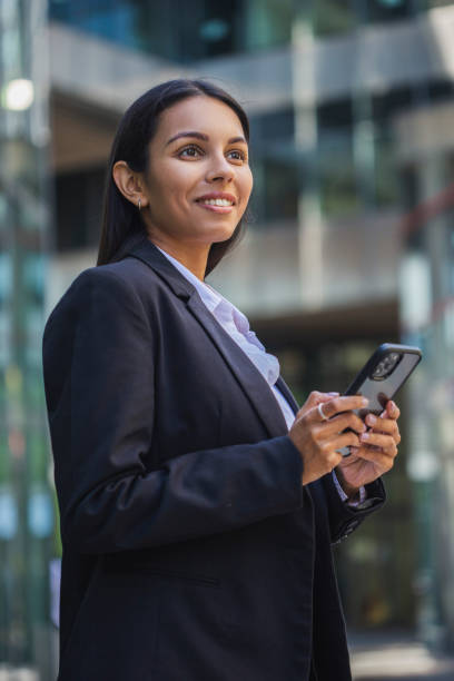 istock Woman using mobile phone on the street 1405280613