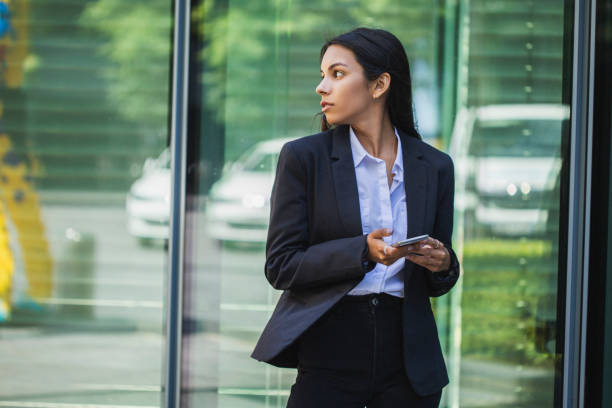 istock Woman using mobile phone on the street 1405280628