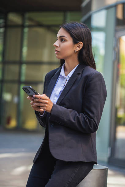 istock Woman using mobile phone on the street 1405280647