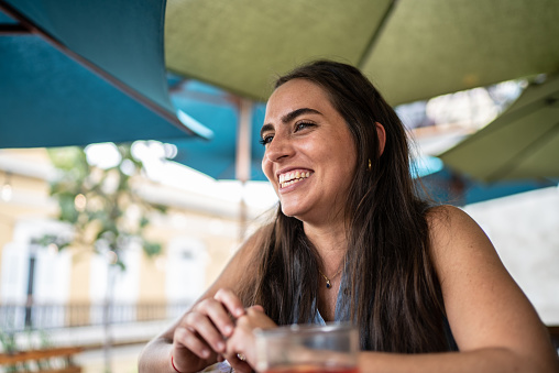 Happy young woman at a restaurant