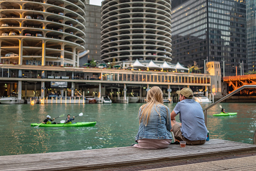 Chicago, IL - September 28, 2021: Friends hang out along Riverwalk, along the Chicago River, downtown in the Loop.