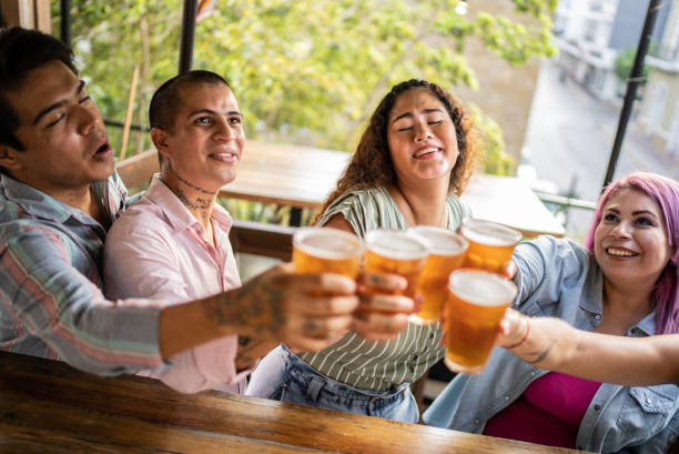 istock Friends drinking beer and doing a celebratory toast at a bar 1405281588