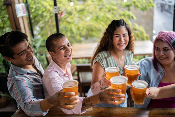 istock Friends drinking beer and doing a celebratory toast at a bar 1405281692