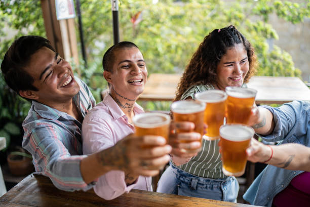 istock Friends drinking beer and doing a celebratory toast at a bar 1405281711