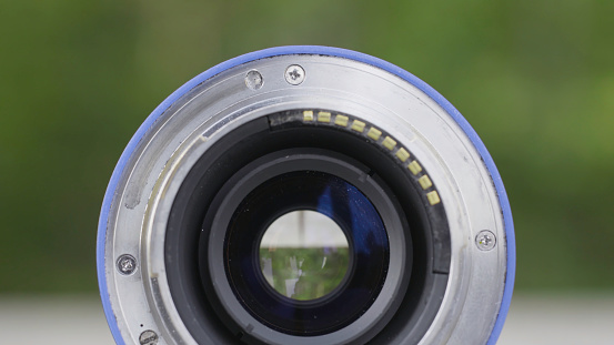 Modern and old DSLR camera lens set on black background with reflection