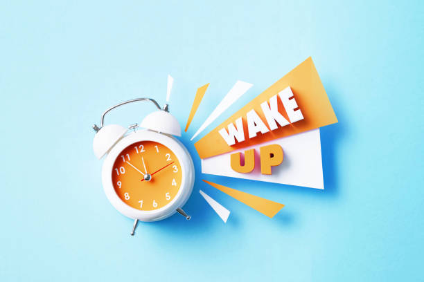 istock Wake Up Reads Next To A White Alarm Clock On Blue Background 1405285083
