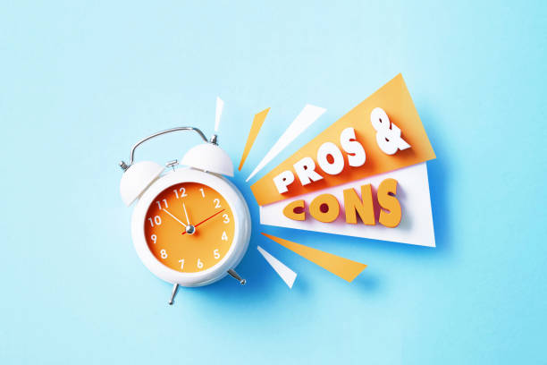 istock Pros And Cons Reads Next To A White Alarm Clock On Blue Background 1405285107