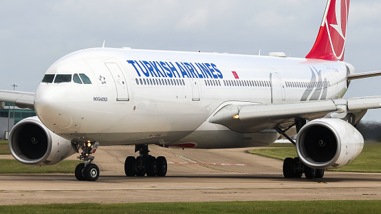 Manchester Airport, United Kingdom - 10 June 2022: Turkish Airlines Airbus A330 (TC-JNO) entering runway 23L for take off to Istanbul (IST), Turkey.