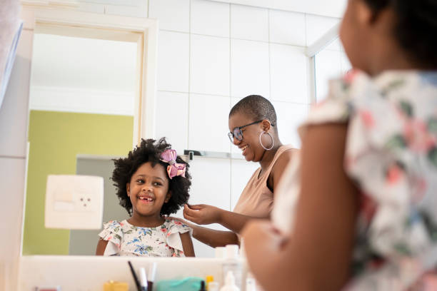 istock Sisters combing their hair in the bathroom 1405285235