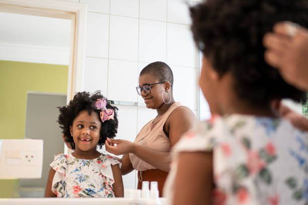 istock Sisters combing their hair in the bathroom 1405285237