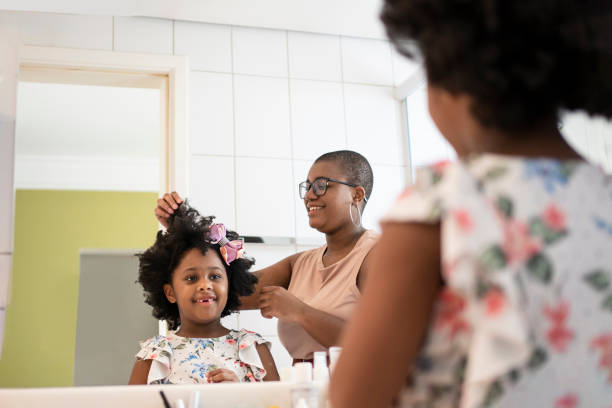 istock Sisters combing their hair in the bathroom 1405285240
