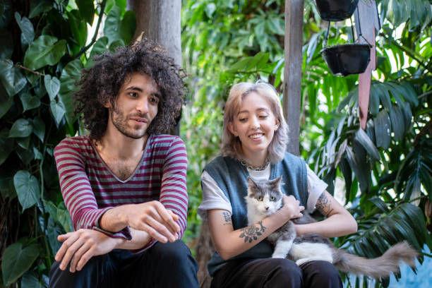 istock Non binary person and friend playing with cat 1405291709