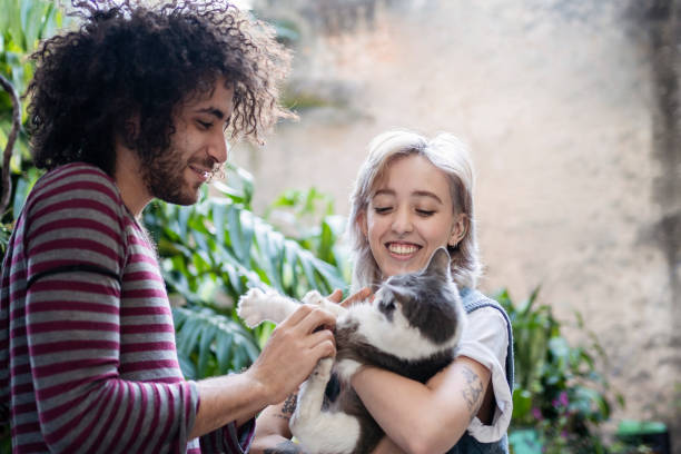 istock Non binary person and friend playing with cat 1405291734