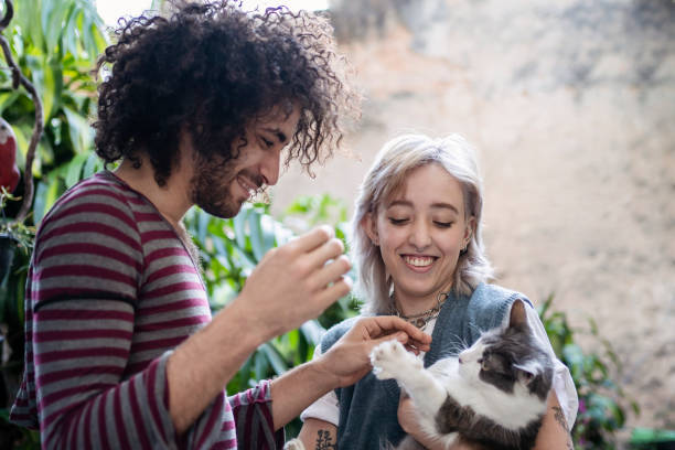 istock Non binary person and friend playing with cat 1405291740