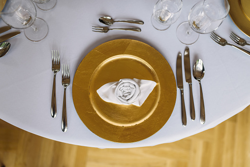 Banquet tables with cutlary ready for wedding reception.