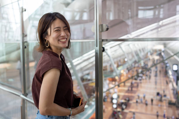 Woman smiling in airport before flying stock photo