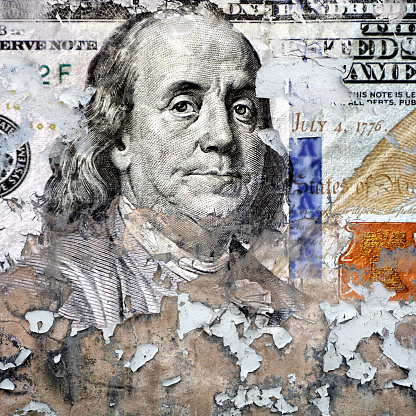 Conceptual finance image of close up torn American one hundred dollar bill