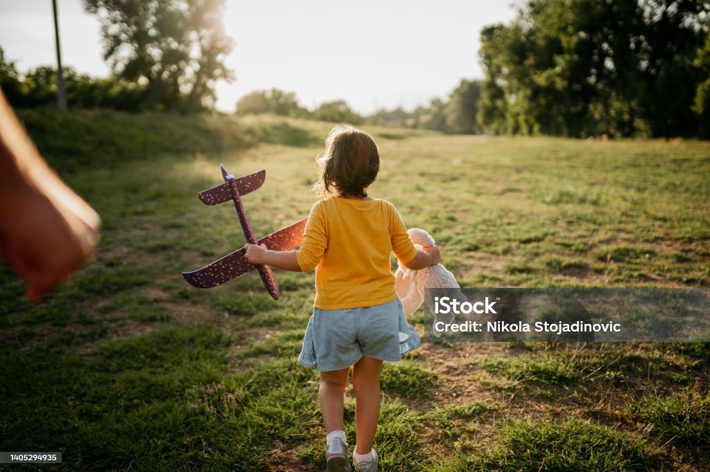 The father is playing with his daughter and the plane Child Stock Photo