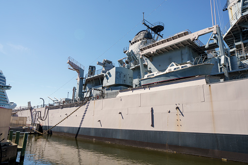 Navy frigate moored at naval dockyard.