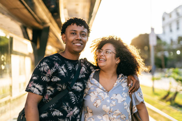 Smiling couple on urban train platform Smiling couple on urban train platform. Rio de Janeiro VLT Carioca. body positive couple stock pictures, royalty-free photos & images