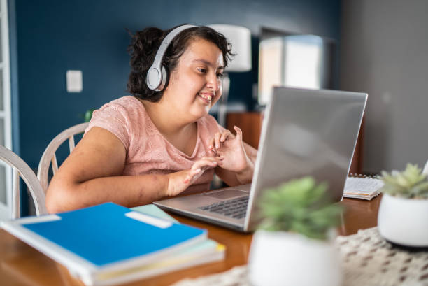 istock Psychomotor Intellectual disability girl using laptop studying at home 1405304067