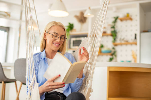 istock Woman relaxing and reading a book 1405307073