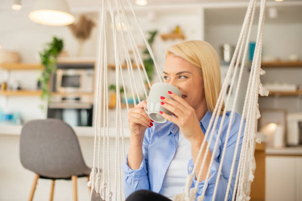 istock Beautiful woman relaxing and drinking hot tea 1405307079