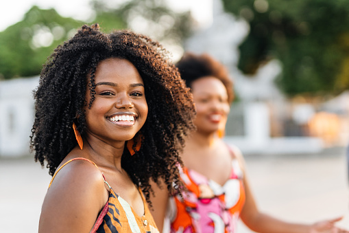 Smiling black woman in Rio de Janeiro city at sunset