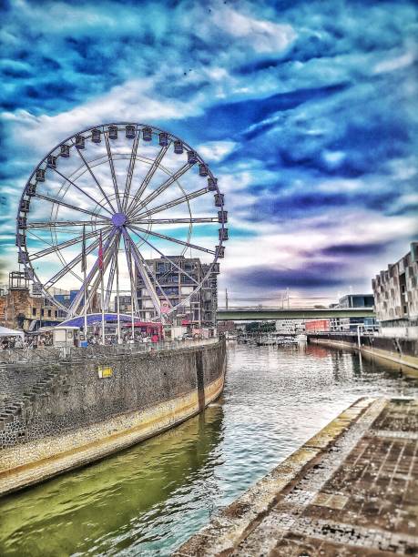 istock Ferris wheel standing at the riverside and harbor 1405308022