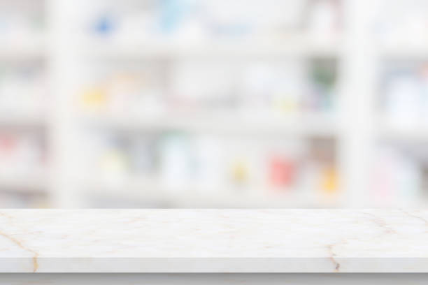 istock Empty white marble counter top with blur pharmacy drugstore shelves background 1405308076