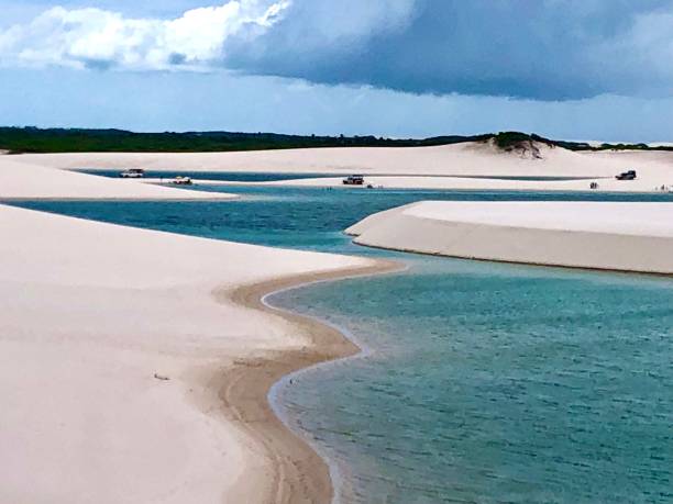 Blue waters and white sand on the Lencois Maranhenses dunes. Lençóis Maranhenses with white sand dunes and blue water lagoons brazil desert maranhao state national park stock pictures, royalty-free photos & images