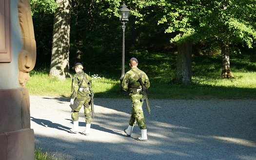 Royal Guards on patrol, in the grounds of the Drottningholm Palace park, Drottningholm, Sweden