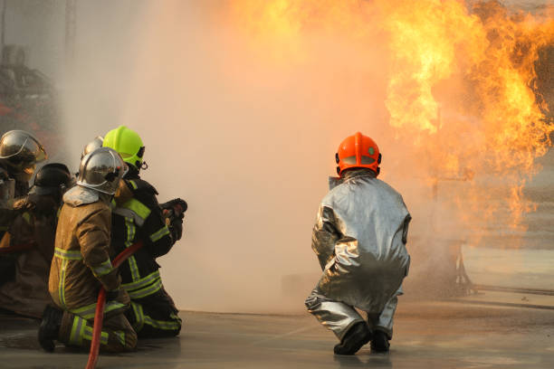 istock Firefighters using Twirl water fog type fire extinguisher to fighting with the fire flame from oil to control fire not to spreading out. Firefighter and industrial safety concept. 1405329070