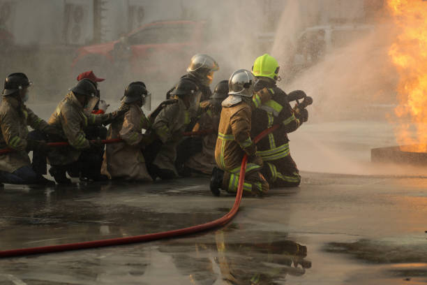 Man using water hose to clean the ground