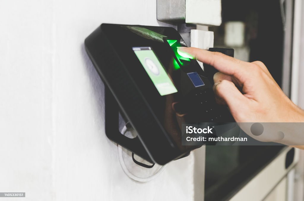 Gaining access finger print scan Side view of hand scanning fingerprint to screening system gain entry security to building the office. Biometric locks control access to record working time. Biometrics Stock Photo