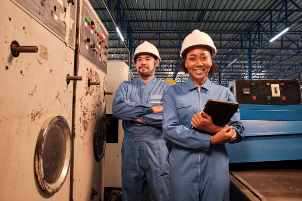 istock Professional industry engineers partner looking at camera and smile in factory. 1405330154