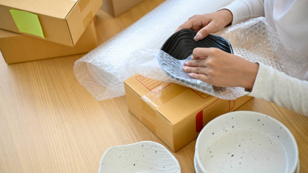 istock A female small business entrepreneur packing her kitchenware product into a cardboard box 1405330190