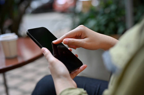 istock A female using mobile phone, typing on smartphone screen, scrolling on the phone. 1405330423