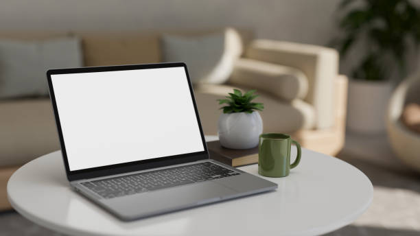 istock Portable notebook laptop mockup on coffee table in modern comfortable living room. 1405330990