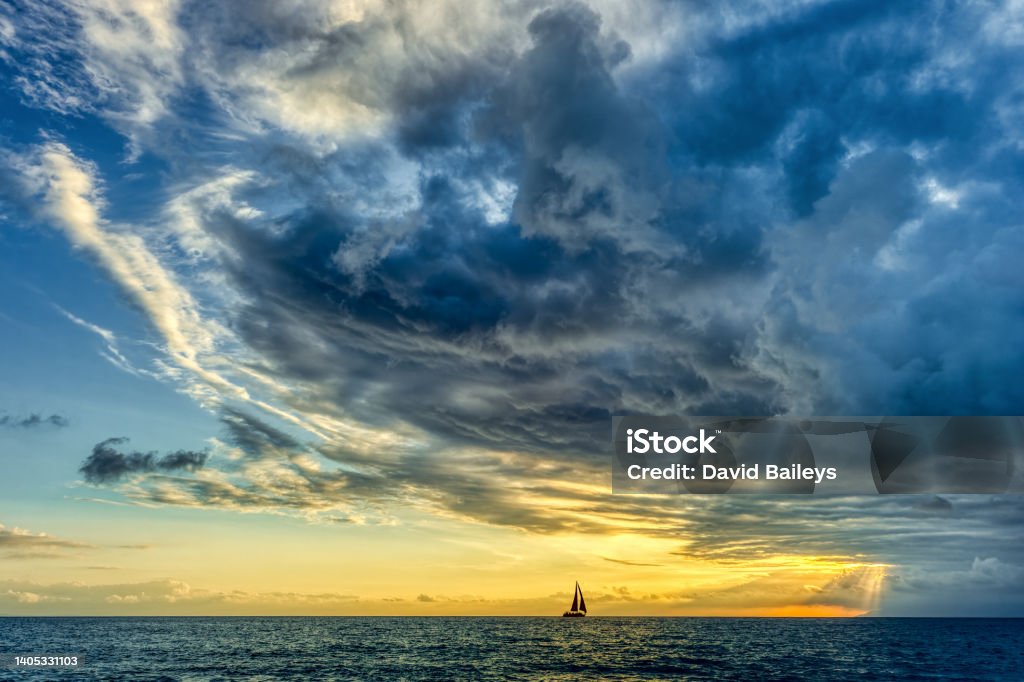 Sunset Sailboat Storm Looming Ocean Clouds A Storm Is Looming Overhead As A Small Boat Moves Toward The The Shining Light Storm Stock Photo